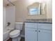 This bathroom offers a granite countertop and a tub with a shower featuring tiled walls at 994 Chapman Cir, Stone Mountain, GA 30088