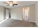 Neutral bedroom with plush carpeting, ceiling fan and view of bathroom at 994 Chapman Cir, Stone Mountain, GA 30088