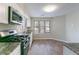 Well-lit kitchen featuring stainless steel appliances, granite countertops, and plenty of counter space at 994 Chapman Cir, Stone Mountain, GA 30088