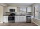 Updated kitchen featuring stainless steel appliances, granite countertops, and white cabinets at 994 Chapman Cir, Stone Mountain, GA 30088