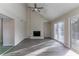 Bright living room with a stone fireplace, high ceilings, and sliding doors to the outdoor deck at 994 Chapman Cir, Stone Mountain, GA 30088