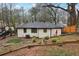 Backyard of home with neutral siding, new fence, small patio set, and minimal, manicured landscaping at 1090 Indale Sw Pl, Atlanta, GA 30310