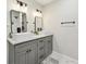 Bathroom featuring dual sinks, modern mirrors and updated lighting at 1090 Indale Sw Pl, Atlanta, GA 30310