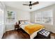 Cozy bedroom with hardwood floors, neutral paint, ceiling fan, and two windows at 1090 Indale Sw Pl, Atlanta, GA 30310