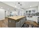 Open kitchen layout with large island, stainless steel sink and modern light fixtures at 1090 Indale Sw Pl, Atlanta, GA 30310