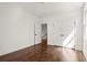 Bright bedroom featuring hardwood floors, a closet, and a door leading to the stairwell at 1183 Mobile Nw St, Atlanta, GA 30314