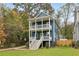 Charming two-story home boasts double porches, a blue facade, and a vibrant yellow front door at 1183 Mobile Nw St, Atlanta, GA 30314