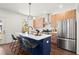 Modern kitchen with wood cabinets, stainless steel appliances, and a blue island with a white countertop at 1183 Mobile Nw St, Atlanta, GA 30314