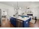 Open-concept kitchen featuring a blue island with quartz countertops and stainless steel appliances at 1183 Mobile Nw St, Atlanta, GA 30314