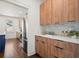 Modern kitchen with wood cabinets, stainless steel appliances, and a white subway tile backsplash at 1183 Mobile Nw St, Atlanta, GA 30314