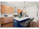 Stylish kitchen with wood cabinets, white subway tile backsplash, and island with seating at 1183 Mobile Nw St, Atlanta, GA 30314