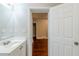 Bathroom sink and doorway lead to a room with newly refinished hardwood flooring at 1850 Brewer Sw Blvd, Atlanta, GA 30310