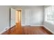 Bedroom features refinished hardwood floors, neutral paint, and a window for natural light at 1850 Brewer Sw Blvd, Atlanta, GA 30310