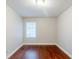 Bedroom boasts refinished hardwood floors and a window providing ample natural light at 1850 Brewer Sw Blvd, Atlanta, GA 30310