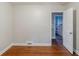 An open door leads to a bathroom with pink tile from a bedroom with hardwood flooring at 1850 Brewer Sw Blvd, Atlanta, GA 30310