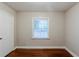 Bedroom with hardwood floors, neutral walls, white trim and a large window at 1850 Brewer Sw Blvd, Atlanta, GA 30310