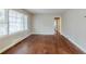 Bright living room with wood floors, neutral walls, a large window and connected hallway at 1850 Brewer Sw Blvd, Atlanta, GA 30310