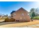 Exterior of brick home displaying a well-maintained backyard and grassy lawn at 3135 Preservation Cir, Lilburn, GA 30047