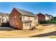 The backyard showcases a two-story brick home with a well-kept lawn and patio area at 3135 Preservation Cir, Lilburn, GA 30047