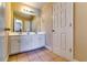 Bathroom features a double sink vanity, large mirror, and clean neutral finishes at 3135 Preservation Cir, Lilburn, GA 30047