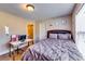 Cozy bedroom featuring a work desk, plush bedding, and bright natural light from a window at 3135 Preservation Cir, Lilburn, GA 30047