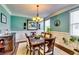 Bright dining room featuring wainscoting, hardwood floors, and a pendant chandelier at 3135 Preservation Cir, Lilburn, GA 30047