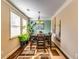 Bright dining room with large windows, modern light fixture, and stylish decor at 3135 Preservation Cir, Lilburn, GA 30047