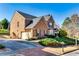 Charming brick home featuring an attached two-car garage and well-manicured front lawn at 3135 Preservation Cir, Lilburn, GA 30047