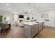 Open-concept kitchen featuring island seating, modern lighting, and view to the living area at 3610 Silvery Way, Powder Springs, GA 30127