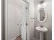 Stylish powder room with pedestal sink, oval mirror, and modern lighting at 3610 Silvery Way, Powder Springs, GA 30127