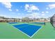 Community tennis courts featuring blue surface and a view of neighborhood homes at 3610 Silvery Way, Powder Springs, GA 30127