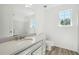 Bright bathroom featuring a modern vanity, a large mirror, and a toilet with wood-look flooring at 6474 E Meyer Dr, Morrow, GA 30260