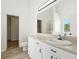 Bright bathroom featuring a modern vanity, a large mirror, and wood-look flooring at 6474 E Meyer Dr, Morrow, GA 30260