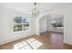 Sunlit dining area showcasing hardwood floors, large windows, and classic wainscoting at 6474 E Meyer Dr, Morrow, GA 30260