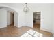 Bright dining room with hardwood floors, modern chandelier, and classic wainscoting at 6474 E Meyer Dr, Morrow, GA 30260