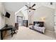 Bedroom with vaulted ceiling, a ceiling fan, built-in bookcase and carpet floors at 1034 Fairview Club Cir, Dacula, GA 30019