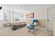 Bedroom with a four-poster bed, rocking chair and natural light streaming through windows at 1034 Fairview Club Cir, Dacula, GA 30019