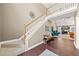 Open living room with a staircase to the second floor, wood flooring, and plenty of natural light at 1034 Fairview Club Cir, Dacula, GA 30019