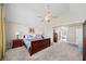 Spacious primary bedroom suite featuring a tray ceiling, and an adjoining ensuite bathroom at 1034 Fairview Club Cir, Dacula, GA 30019