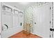 Mud room with wainscoting, tile floors, built-in storage, and decorative wallpaper at 1034 Fairview Club Cir, Dacula, GA 30019