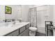 Bathroom featuring a gray vanity with a white countertop, a toilet, and a shower with a patterned curtain at 3320 Reagan Way # 80, Lawrenceville, GA 30044