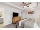 Bedroom features a tray ceiling with a ceiling fan, a wood dresser, and adjacent en suite bath at 3320 Reagan Way # 80, Lawrenceville, GA 30044