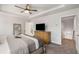 Bedroom with tray ceiling features a ceiling fan and wood dresser, exuding a modern and stylish aesthetic at 3320 Reagan Way # 80, Lawrenceville, GA 30044