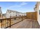 Spacious wood deck with railing offering views of neighboring townhomes, perfect for outdoor living at 3320 Reagan Way # 80, Lawrenceville, GA 30044