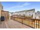 Spacious wooden deck with railing offering views of neighboring townhomes with garages, perfect for entertaining at 3320 Reagan Way # 80, Lawrenceville, GA 30044