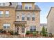 Attractive brick-front townhome featuring a cozy porch and manicured landscaping at 3320 Reagan Way # 80, Lawrenceville, GA 30044