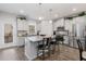 Well-lit kitchen featuring an island with seating, granite countertops, and stainless steel appliances at 3320 Reagan Way # 80, Lawrenceville, GA 30044