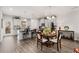 Open-concept kitchen featuring gray cabinets, a granite island, stainless steel appliances, and an adjacent dining area at 3320 Reagan Way # 80, Lawrenceville, GA 30044