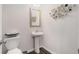 Charming powder room features a pedestal sink, modern mirror and toilet, all in a cozy space at 3320 Reagan Way # 80, Lawrenceville, GA 30044