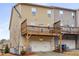 Back of townhome with deck over the garage and neutral siding, creating functional outdoor living space at 3320 Reagan Way # 80, Lawrenceville, GA 30044